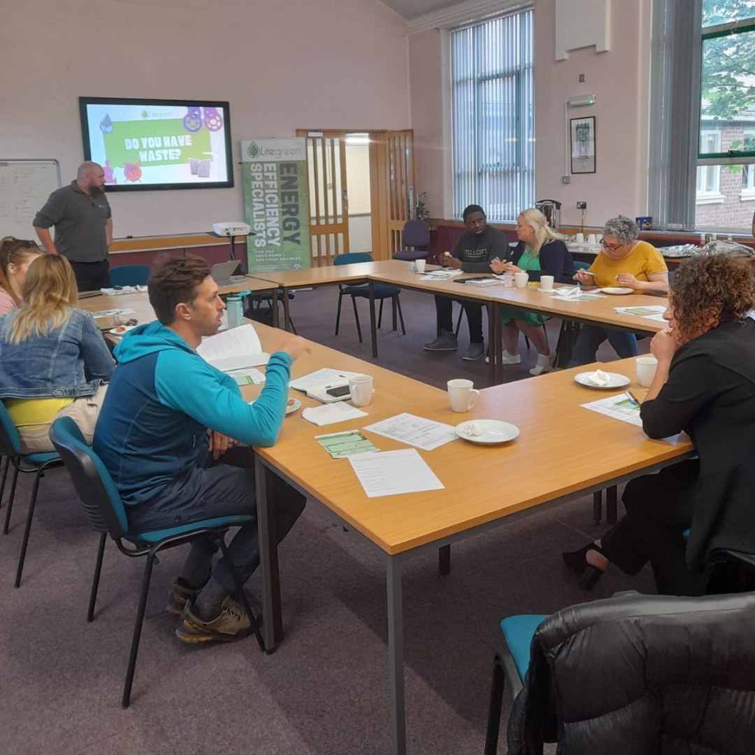 Classroom of people sat around desks during a carbon reduction workshop in North Wales